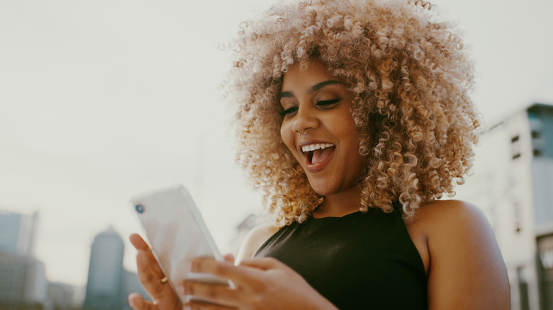 Smiling holding phone