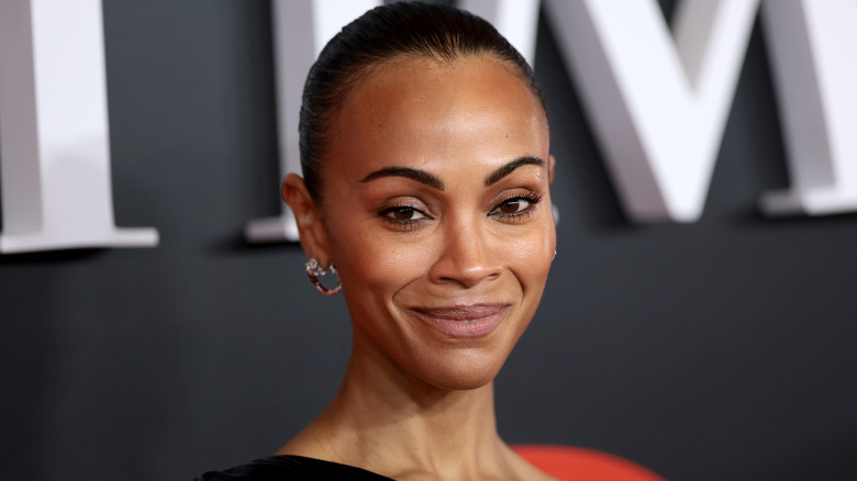 Zoe Saldaña smiles on the red carpet in 2026
