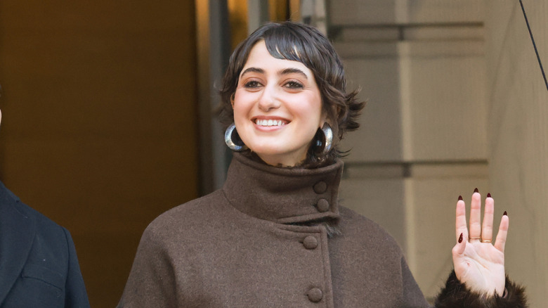 Rama Duwaji smiles wearing a brown winter coat