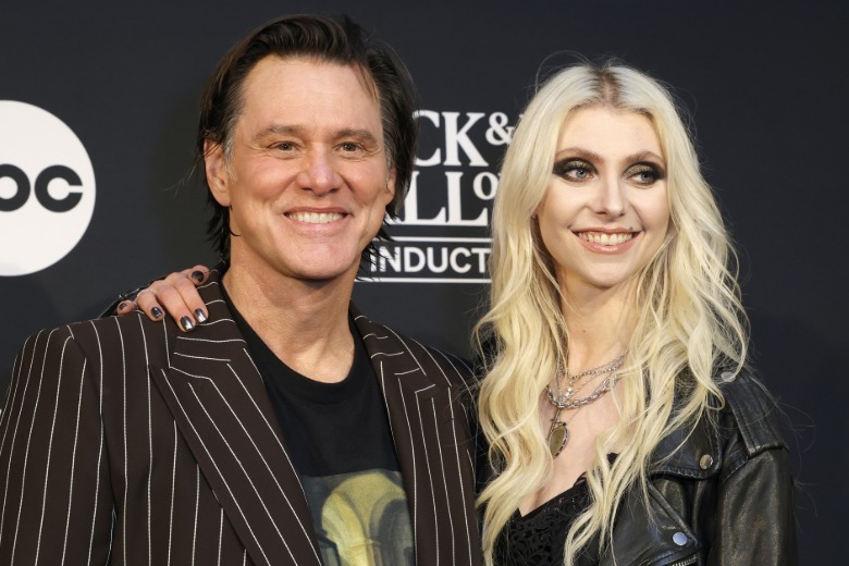 Jim Carrey and Taylor Momsen posing together on the red carpet in 2025