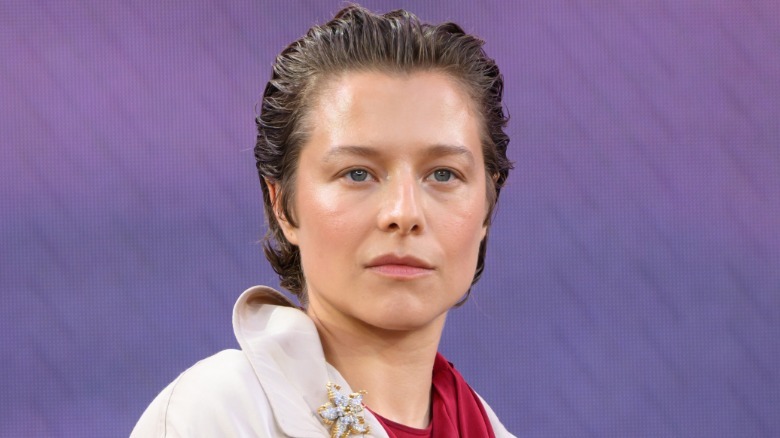 Emma D'Arcy slightly smirking