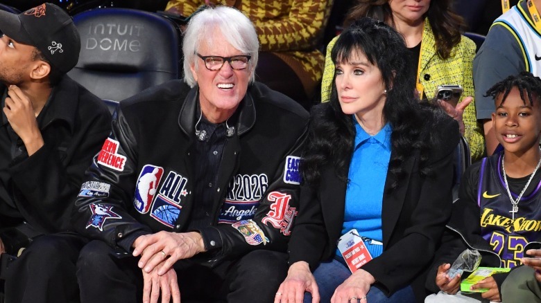 John Tesh and Conni Sellecca pictured in 2026