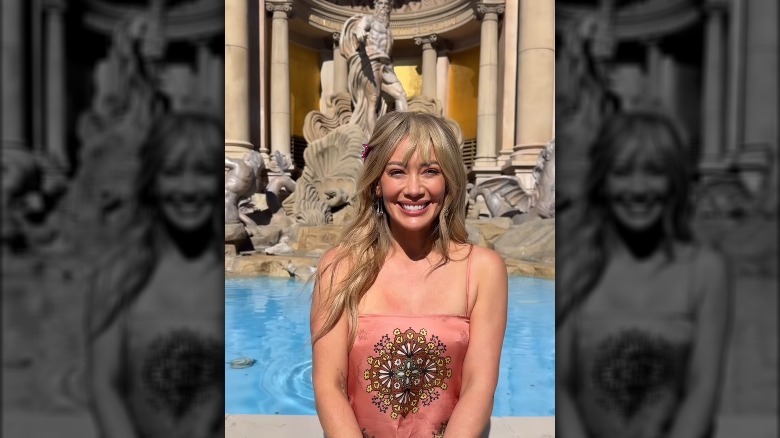 Hilary Duff grins in front of a fountain in 2026