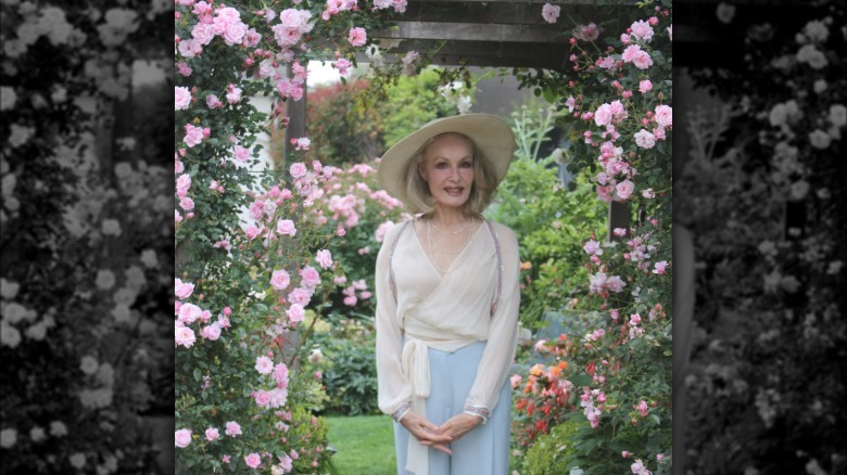 Julie Newmar smiling in her garden in 2026