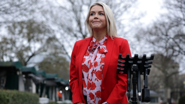 Karoline Leavitt wearing a red blazer in a 2026 press briefing