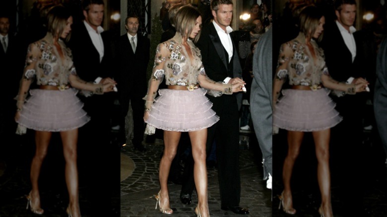 Victoria Beckham and David Beckham walking