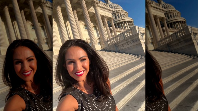 A selfie of Lauren Boebert in front of the Capitol Building with no glasses and red lipstick