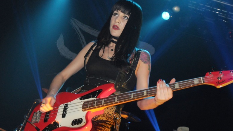 Tatia Starkey playing a guitar on stage