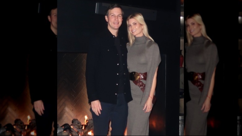 Ivanka Trump and Jared Kushner standing together in front of a fireplace